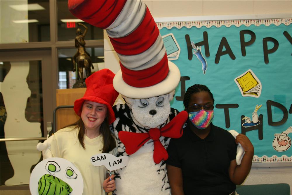 ASBL work students Samantha Taylor and Lilian Jones posing with the Cat. 
